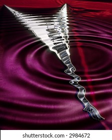Many different scenes reflected in the ripples of a drop into water.