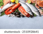 Many different sea food on grey textured table, flat lay. Space for text