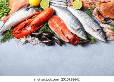 Many different sea food on grey textured table, flat lay. Space for text - Powered by Shutterstock