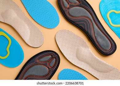 Many different shoe insoles on pale orange background, flat lay - Shutterstock ID 2206638701