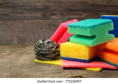 Many different sponges for cleaning on the old wooden background. - Powered by Shutterstock