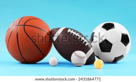 Many different sports balls on light blue background