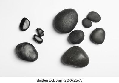 Many different stones on white background, top view