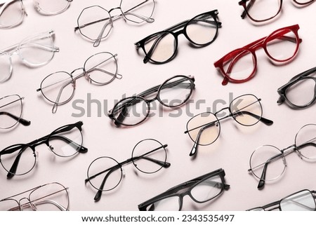 Many different stylish glasses on light grey background, flat lay