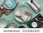 Many different tableware on green background, top view