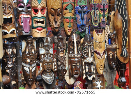 many different tribal masks at a local flea market
