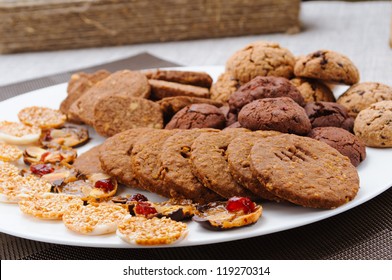 Many Different Types Of Cookies Lay On A Plate