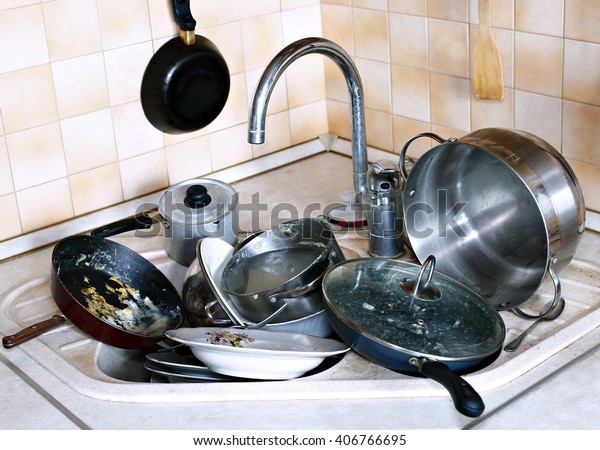 Many of dirty dishes in the sink in the kitchen