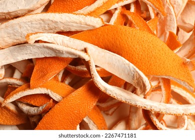 Many dry orange peels on white table, closeup