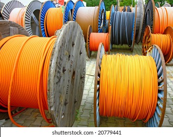 many electricity cables on wooden spools