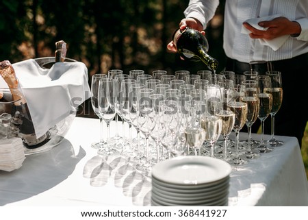 Many elegant empty and half-empty wine glasses of wine or champagne on the festive table in wedding day