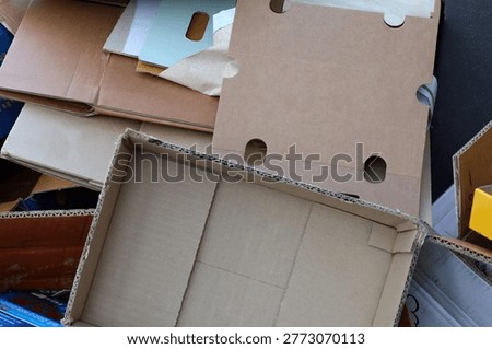Many empty cardboard boxes piled up in a stack.