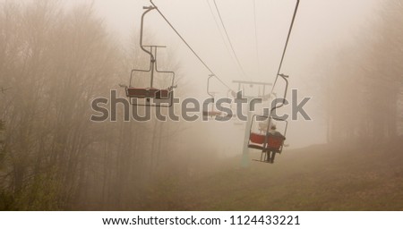 Many empty ski lift chairs in a row close up in the summer