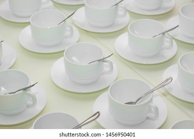 many empty white cups of tea on the table, close up