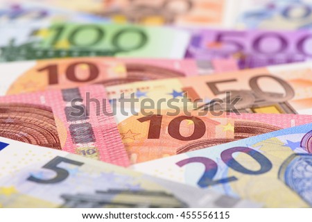 Many Euro banknotes in detail on table