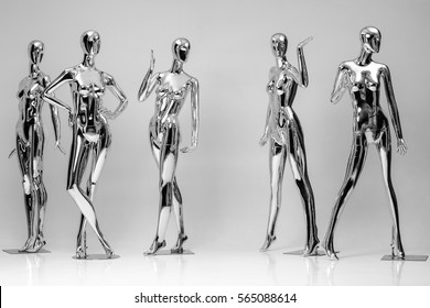 Many Fashion Shiny Female Mannequins For Clothes. Metallic Manne