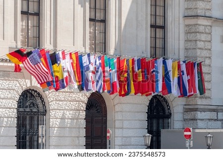Many flags of different countries on the facade of the building, an international organization.