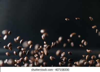 Many Flying Coffee Beans On Black Background