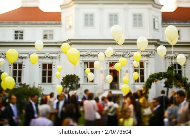 many flying yellow balloons background castle and guests Vienne Austria