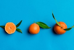 Many Fresh Ripe Mandarin With Green Leaves On Colored Background, Top View, Space For Text.