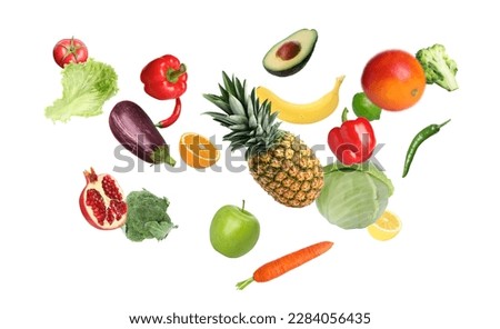 Many fresh vegetables and fruits falling on white background