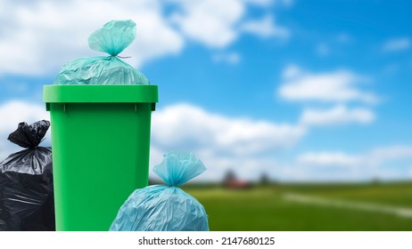 Many garbage bags and full waste bin at the park, waste management concept - Shutterstock ID 2147680125
