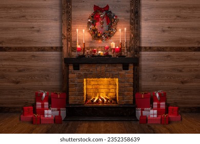 Many gift boxes near the Christmas fireplace in a festive interior of a Log Cabins with wooden walls. Mantelpiece with candles, Christmas wreath with bells and bow - Powered by Shutterstock