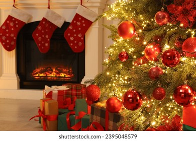 Many gift boxes under decorated Christmas tree and fireplace indoors - Powered by Shutterstock