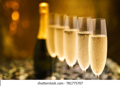 Many glasses of champagne in a line. Selective focus. Vintage tone