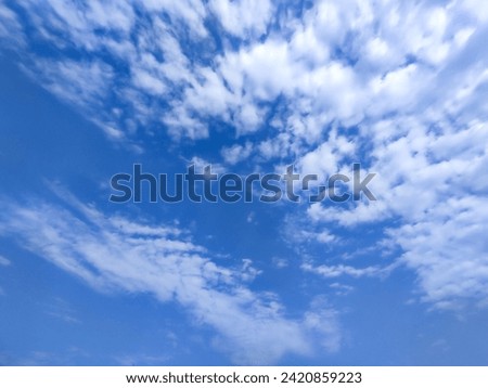Many glowing clouds spreading on the deep blue sky in sunny day. Multitude soft white fluffy clouds covered the blue sky. Nature concept. Elegant white clouds background. Landscape photo