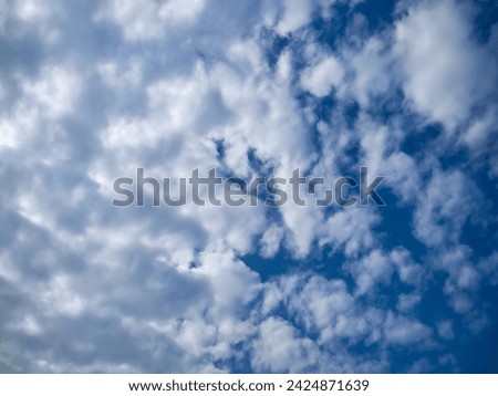 Many glowing clouds spreading on the deep blue sky in daylight. Multitude soft white fluffy clouds covered the blue sky. Nature concept. Elegant rainy white clouds. Landscape photo