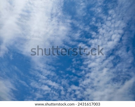 Many glowing clouds spreading on the deep blue sky in daylight. Multitude soft white fluffy clouds covered the blue sky. Nature concept. Elegant white clouds in sunny day. Landscape photo