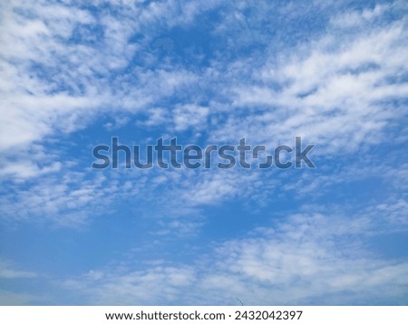 Many glowing clouds spreading on the deep blue sky in daylight. Multitude soft white fluffy clouds covered the blue sky. Nature concept. Elegant white clouds in sunny day. Landscape photo