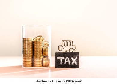 Many Gold Coins Were Put In Money Box And Tax Sign With A Car Symbol Placed Together. Annual Income Tax Return To The Government Sector And Tax On Trading Or Car Ownership Rights Concept.