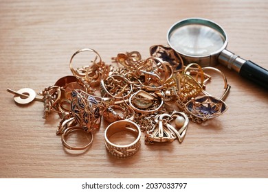 many golden and silver jewerly and magnifying glass, pawnshop concept, jewerly shop concept, closeup