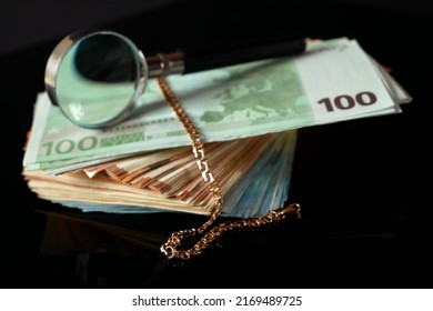 many golden and silver jewerly and magnifying glass, pawnshop concept, jewerly shop concept, closeup
