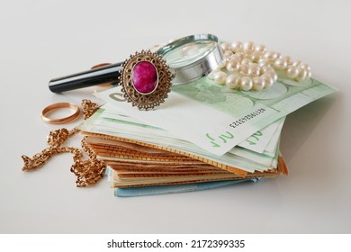 many golden and silver jewerly and money euro stack, pawnshop concept, jewerly shop concept, closeup