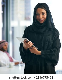 So Many Great Apps To Keep Business Running Smoothly. Portrait Of A Young Muslim Businesswoman Holding A Digital Tablet With Her Colleague Working In The Background.