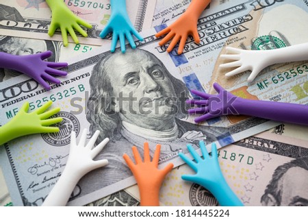 Many hand people borrow money, loan, credit from banking or government on US dollar bill banknotes background. Borrowing or begging money, business and financial concept.