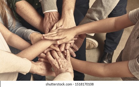 Many hands of a family stacked on each other as a network concept header
