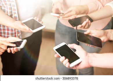 Many Hands Holding Mobile Phones Close Up