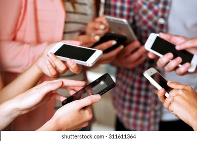 Many Hands Holding Mobile Phones Close Up