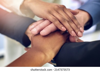 Many Hands And One Vision Make A Successful Team. Closeup Shot Of A Group Of Colleagues Joining Their Hands Together In Unity.