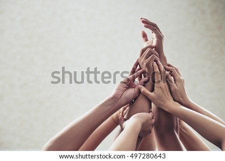 Many hands raised in the air: unity and support