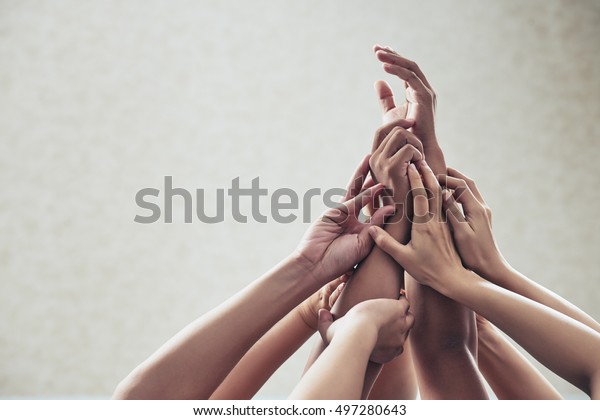 Many hands\
raised in the air: unity and\
support