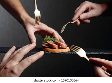 Many Hands Reach For The Last Sandwich. Greed And Gluttony Concept.