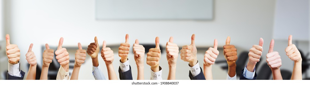 Many hands with thumbs up in the office