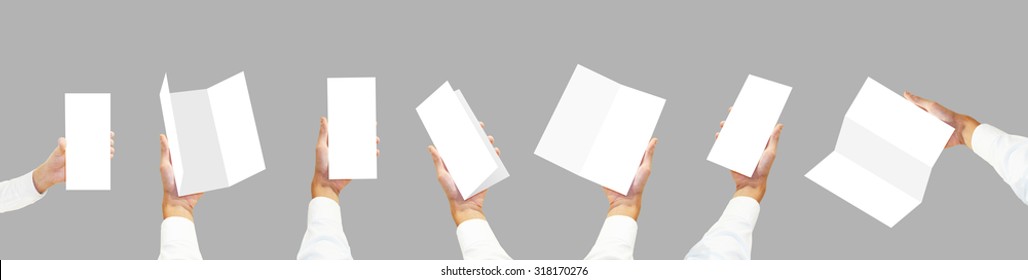 Many Hands In White Shirt Holding Blank Brochure Flyers. Leaflet Presentation. Pamphlet Hold Hands. Man Show Clear Offset Paper. Sheet Template. Booklet Design Sheet Display Read First Person