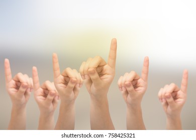 Many hands of a young girls with a fingers up on a blurred background. - Shutterstock ID 758425321