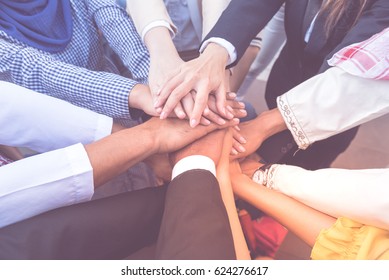 Many Handshake Of Young Arab Business People Join Hug Team Work Out Office. Hand Of Group Corporate Mix Partnership  Multiple Ethnicity. Teamwork Is Importance For Successful Of Trust Business Model.